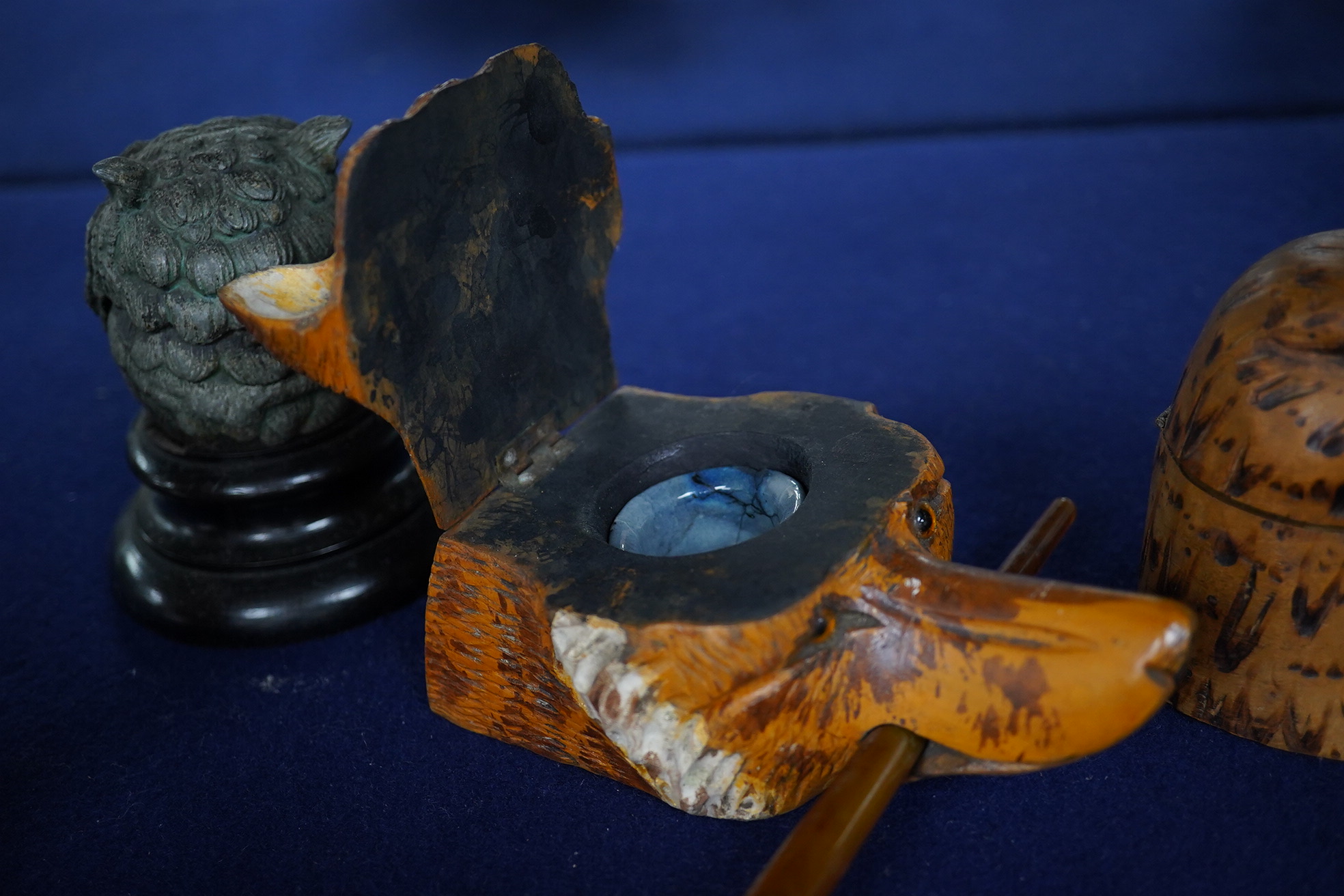 Two carved wood novelty inkwells in the form of animals, one with pen, together with a lead owl inkwell, largest 9cm high. Condition - fair